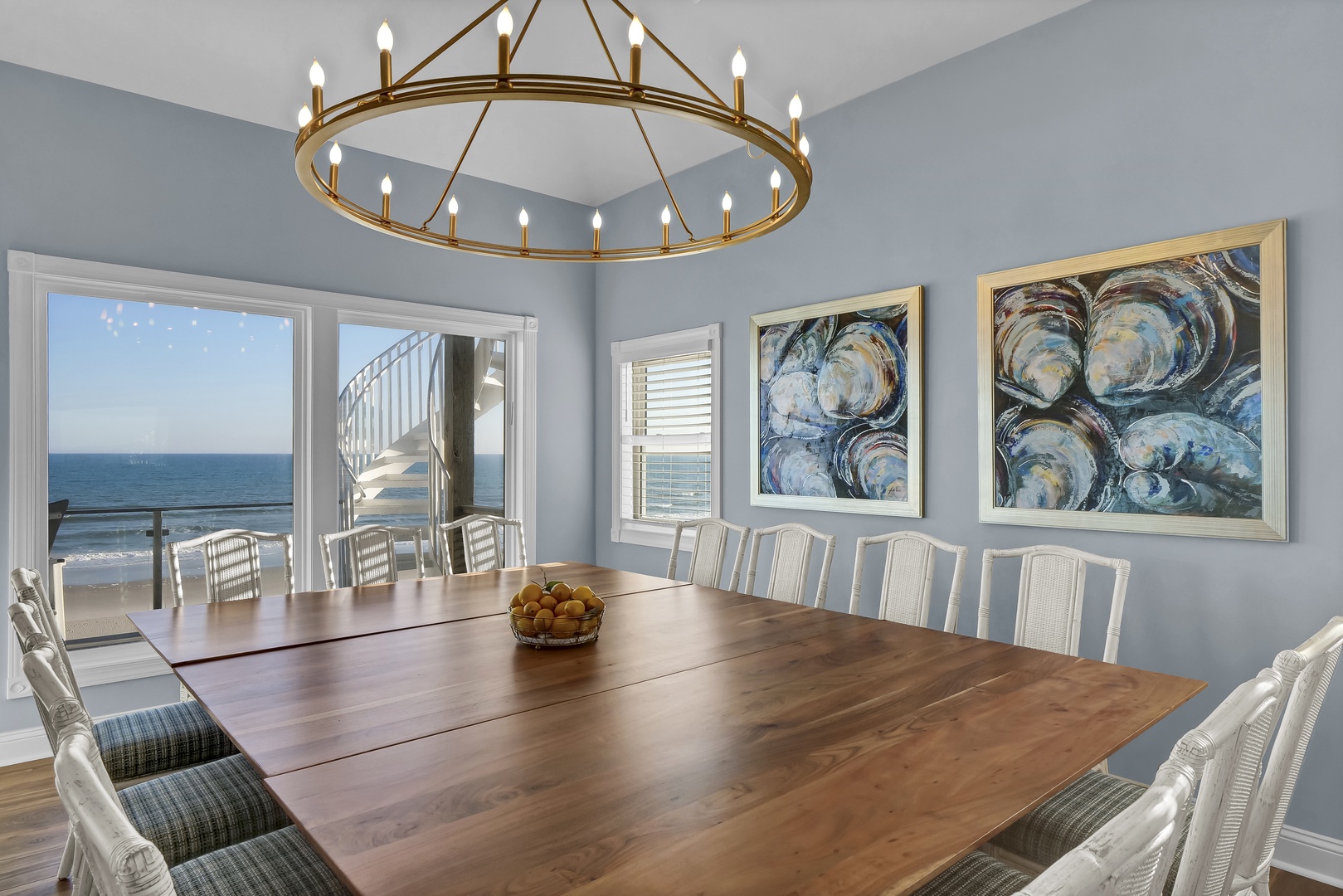 Gather around this elegant dining table with views of the ocean just steps away. The coastal artwork and natural light create the perfect setting for your memorable vacation meals together.