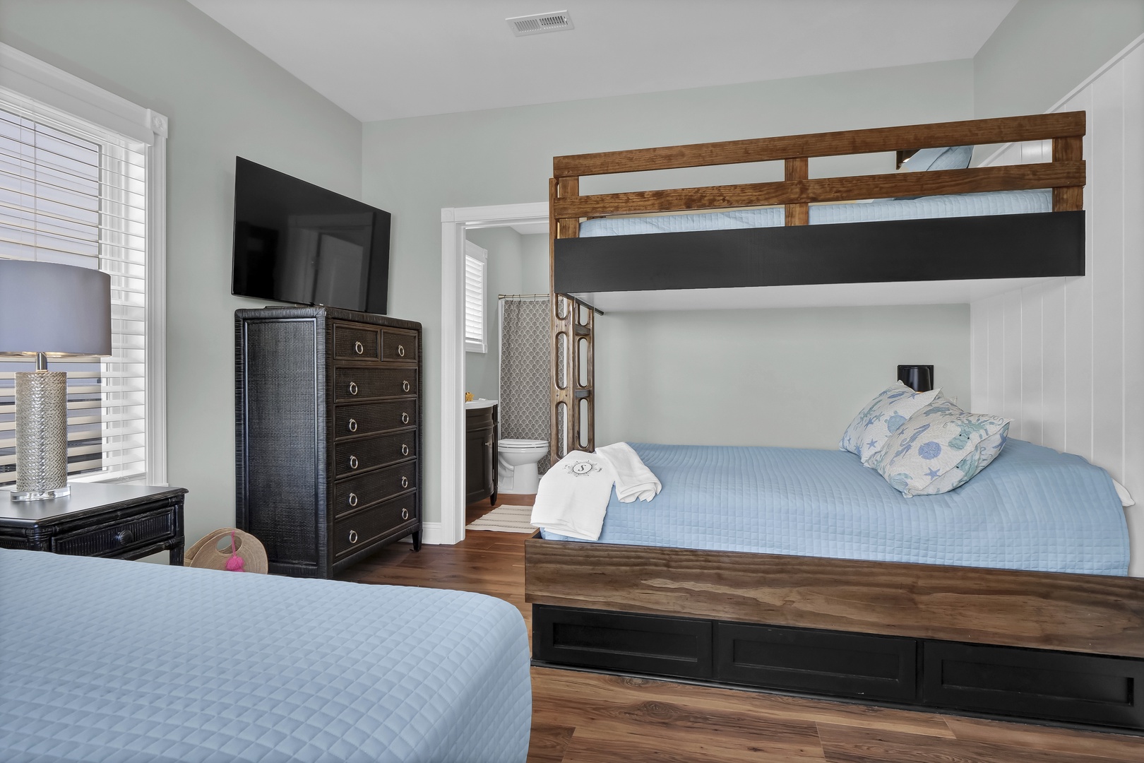 Your bedroom features a custom bunk bed with extra storage and a full bed below, plus a flat-screen TV for cozy nights in—perfect for families or groups looking to share comfortable space.