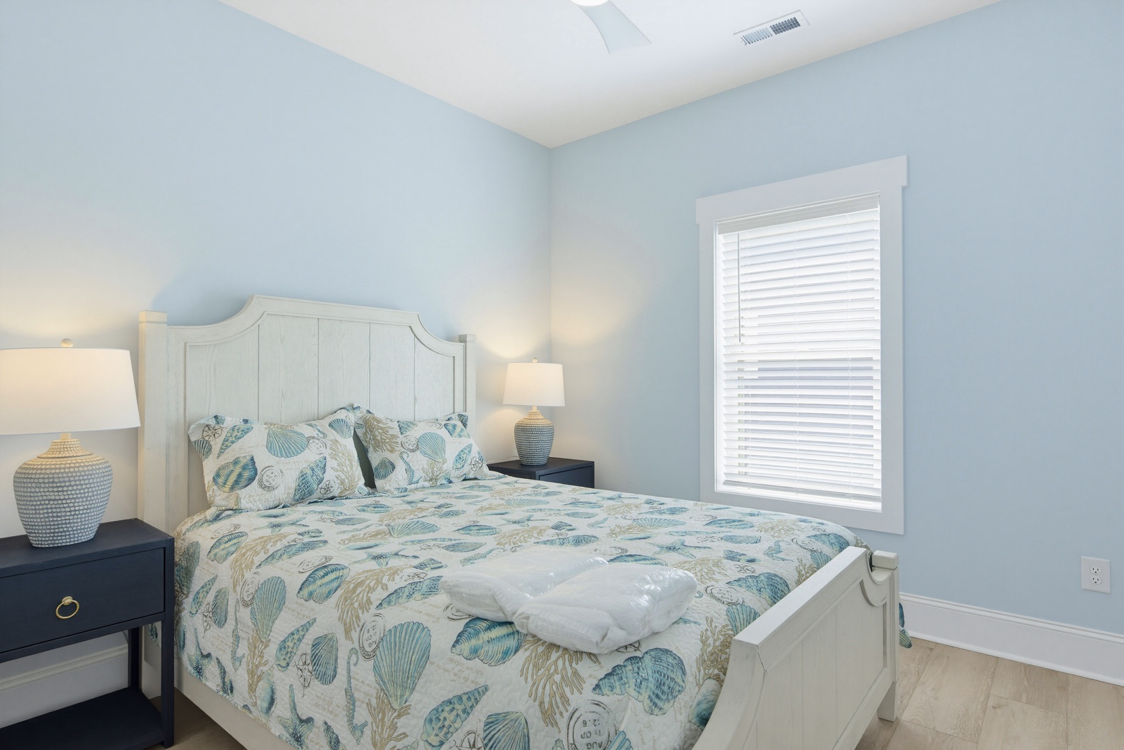Sink into soft bedding and let the calming coastal blues ease you into your vacation. The bedside lamps cast a gentle glow for late-night reading or a peaceful morning wakeup.