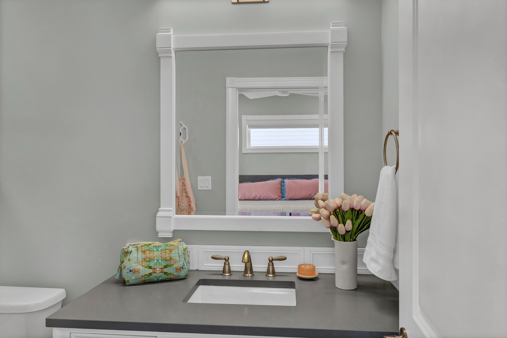 Freshen up in this serene bathroom with elegant finishes and thoughtful touches. The soft sage walls and sleek countertops create a calming atmosphere for your morning routine.