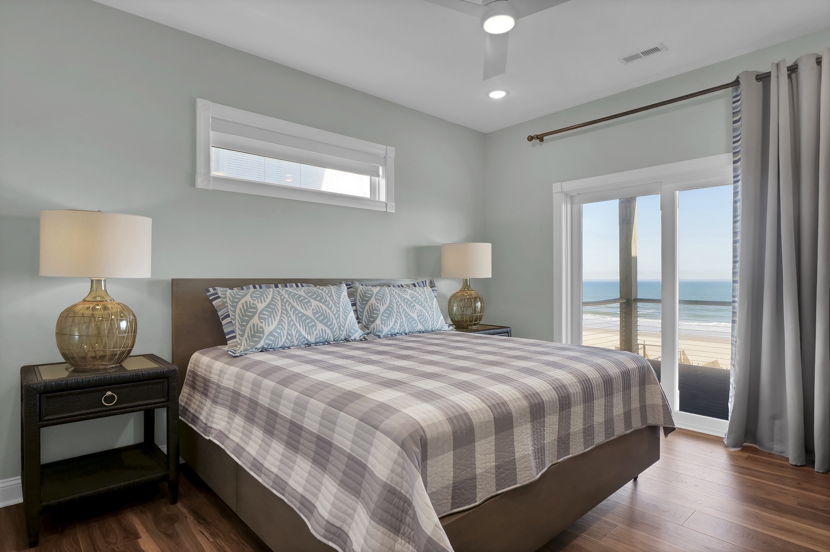 Wake up to stunning ocean vistas right from your bed. Floor-to-ceiling windows frame the sparkling sea, while soft coastal tones and plush bedding create your perfect retreat after a day of beach adventures.