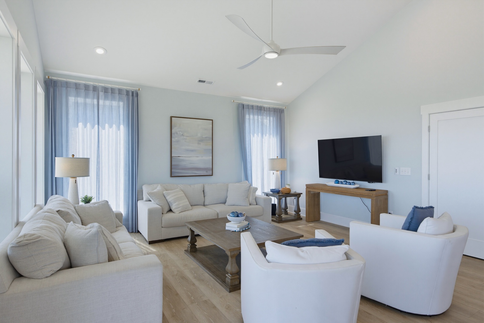Sink into plush seating and unwind in your bright, airy living space with vaulted ceilings. Coastal-inspired décor and gentle breezes from the ceiling fan set the scene for effortless relaxation.