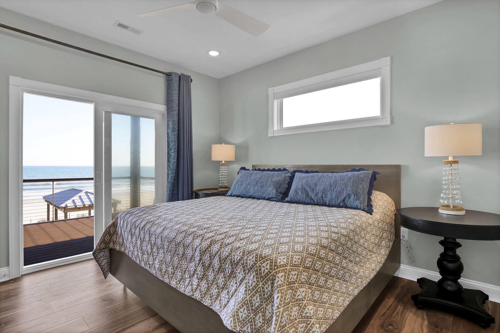 Wake up to ocean breezes and step onto your private balcony for sunrise coffee. Soft coastal hues and warm wood floors create a serene retreat after beach days.