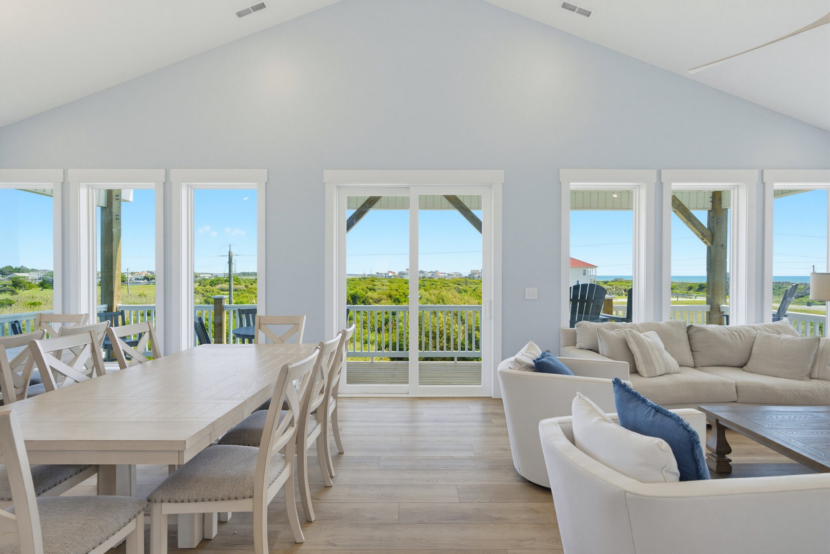 Step into your bright, airy retreat where coastal breezes and sweeping views greet you. Unwind in the plush living area or gather around the dining table—your perfect beachside escape awaits.