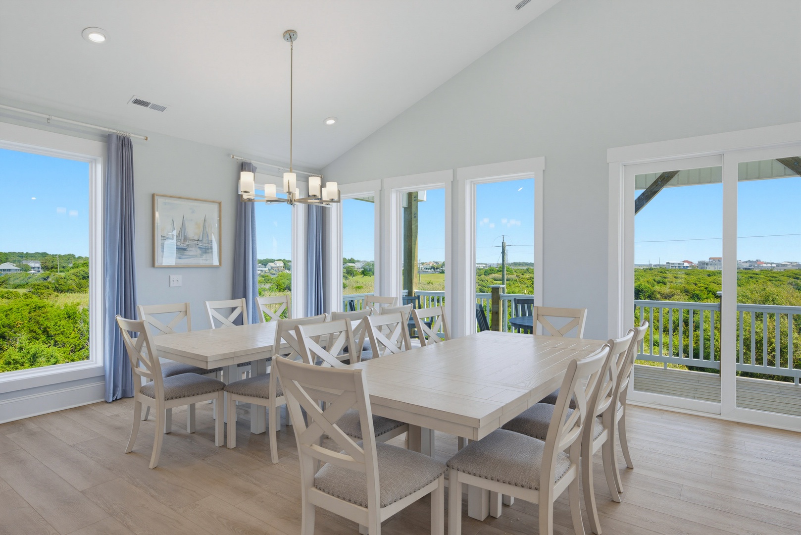 Gather around spacious dining tables with room for everyone, where coastal breezes drift through open doors and natural light floods the space—your perfect setting for leisurely breakfasts and lively dinners with loved ones.