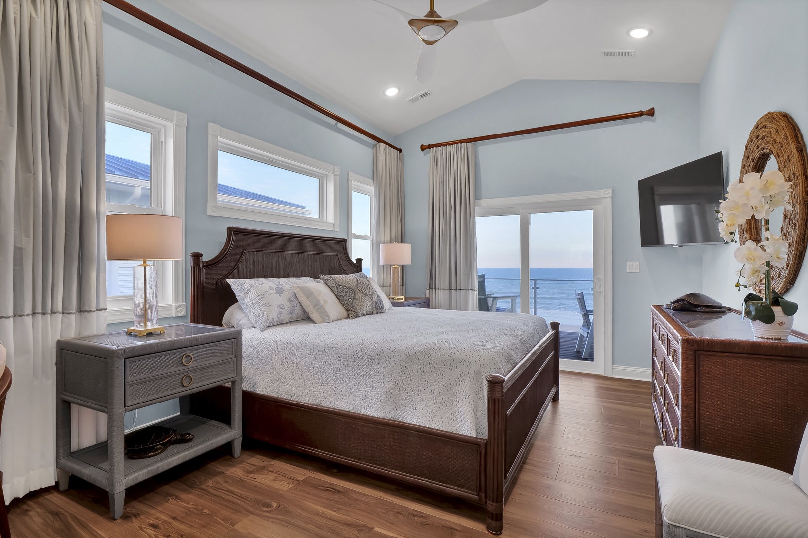 Wake up to serene coastal views right from your bed. This elegant bedroom opens directly onto a private balcony where the ocean stretches endlessly before you, creating the perfect retreat for rest and relaxation.
