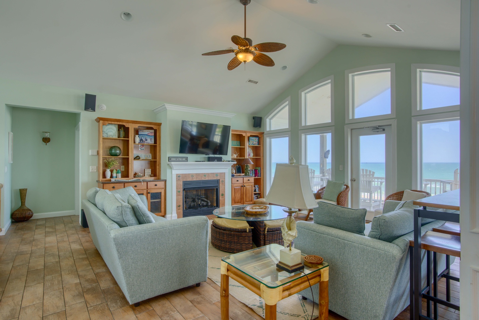 Unwind in your spacious living room with breathtaking ocean views framing every moment. Soft coastal tones and comfortable seating invite you to relax by the fireplace while gentle sea breezes drift through.