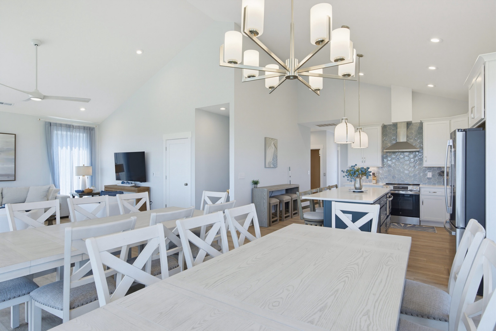 Gather around the welcoming dining table and spacious kitchen island in this bright, open-concept space. Vaulted ceilings and natural light create an airy, modern retreat perfect for meals and conversation.