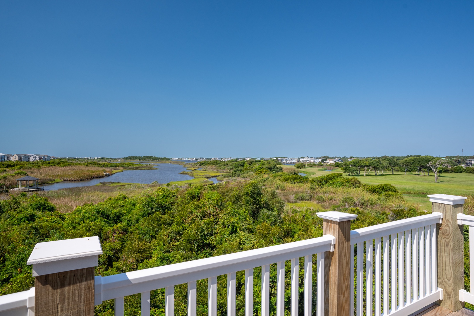 This property features expansive views over lush marshlands, winding waterways, and a nearby golf course—a serene coastal setting that frames your stay.