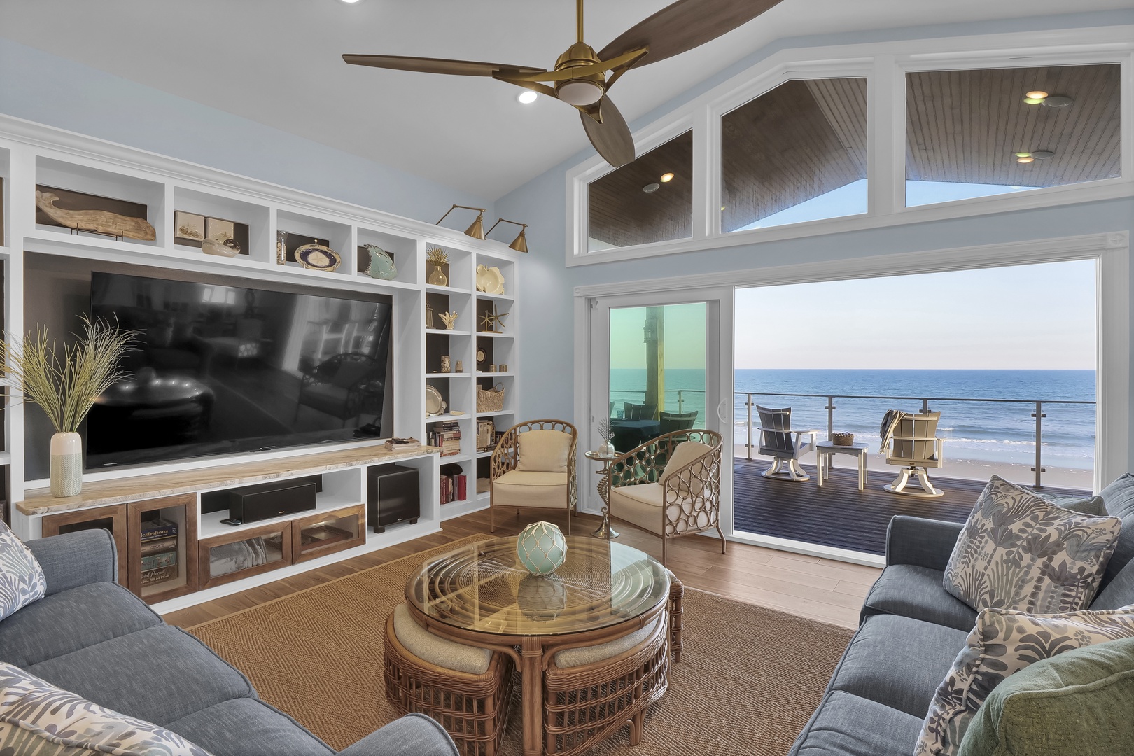 Open the glass doors and feel the ocean breeze. Your coastal living room flows seamlessly onto a private deck where the beach is just steps away—perfect for morning coffee or sunset watching.