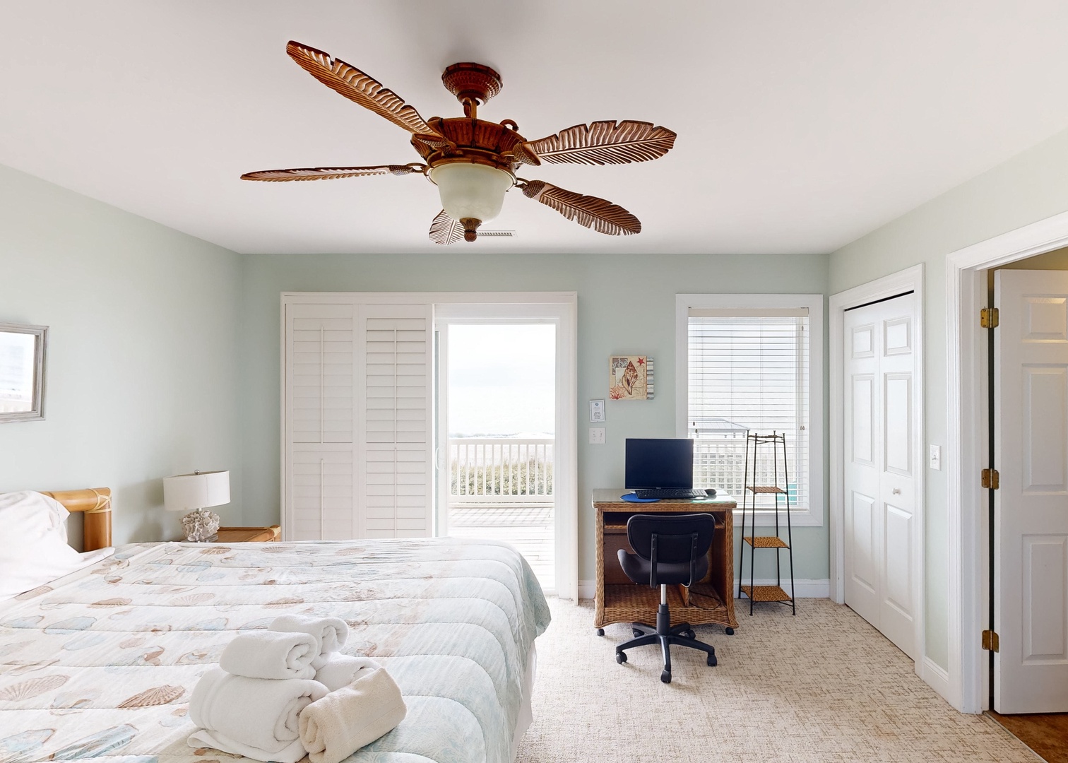 Wake up to ocean breezes and soft morning light streaming through your private balcony doors. Your peaceful coastal retreat features a work-friendly desk, tropical ceiling fan, and beach views just steps away.