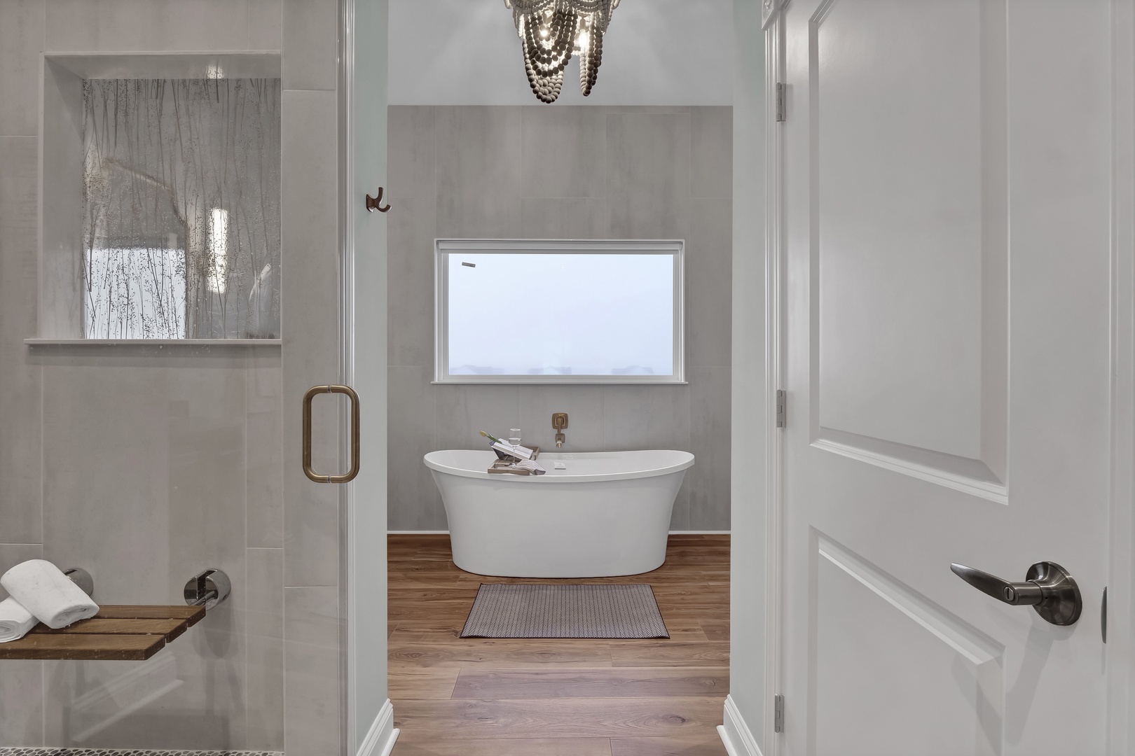 Step into your private spa-like retreat with a luxurious soaking tub, elegant rainfall shower, and warm wood accents that invite deep relaxation.