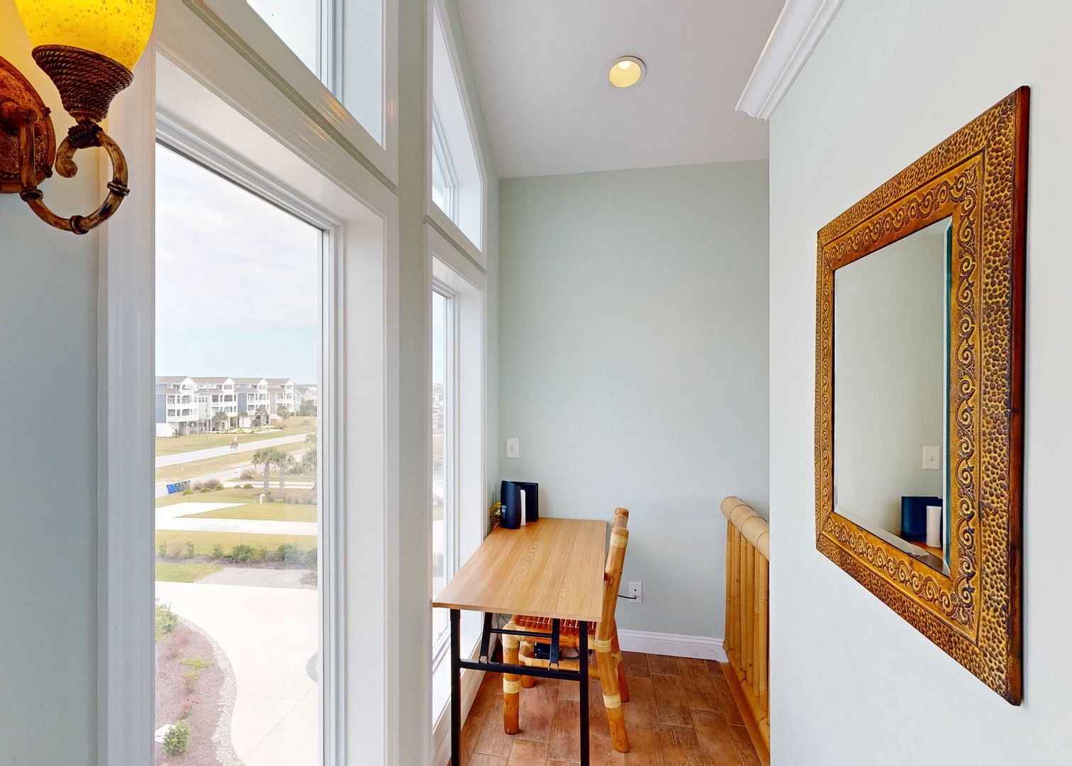 A quiet corner bathed in natural light, perfect for your morning coffee or journaling. Sink into the chair and gaze out over the neighborhood greenspaces and palm trees.