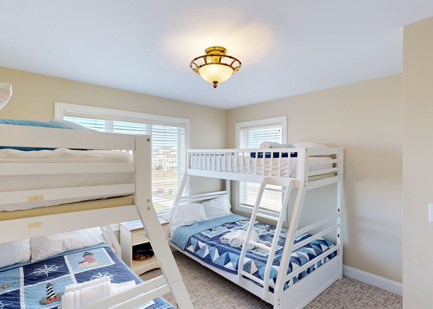 Your family can unwind in this cheerful bedroom with fresh coastal bedding and two sets of bunk beds perfect for kids or groups traveling together.