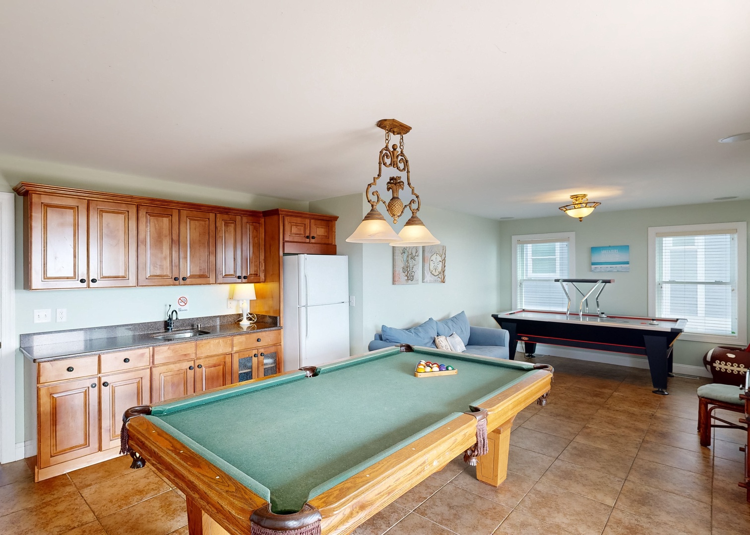Your own private game room awaits—challenge friends to pool, shuffle pucks across the table, then relax on the cozy sectional with drinks from your kitchenette.