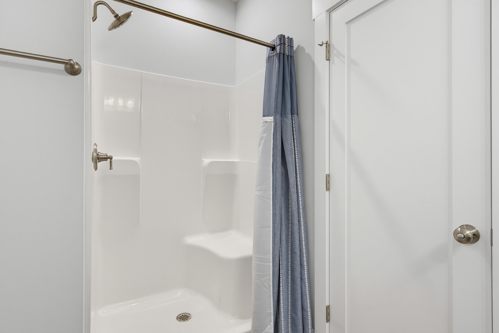 Your private bathroom features a clean walk-in shower with modern fixtures and fresh towels, ensuring a comfortable and refreshing stay.