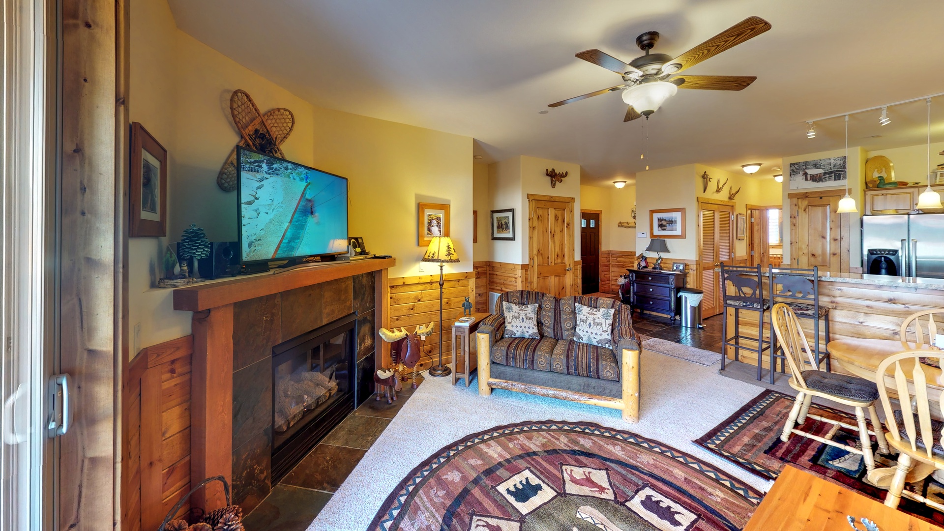 Living room with nearby kitchen and door to deck and nearby kitchen: Truckee Cinnabar Vacation Retreat