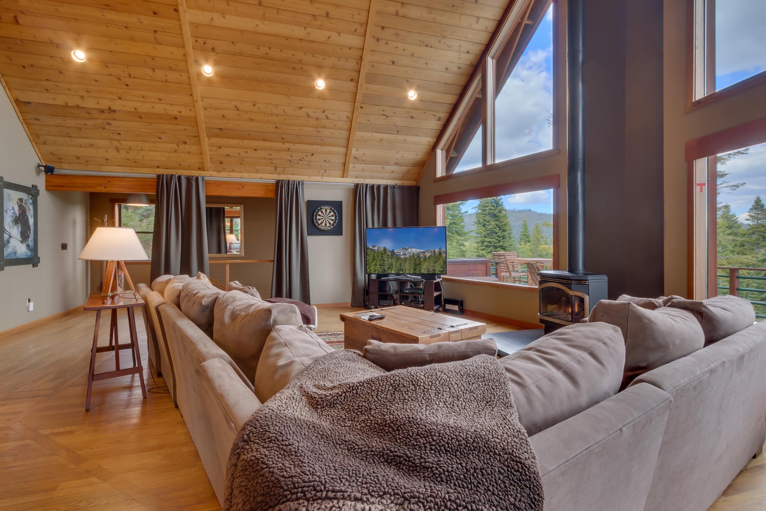Living room featuring large couch and television: Falcon's Eye View Retreat