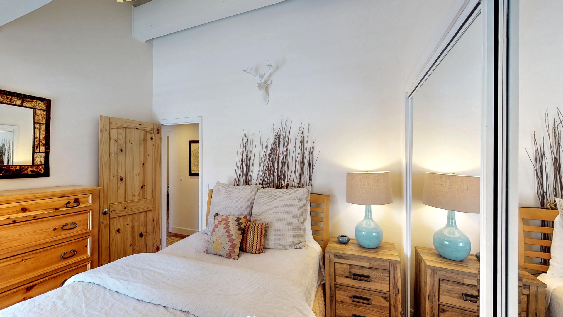 Bedroom with wall mirror~ single bed and dresser: Eagle's Nest Lodge