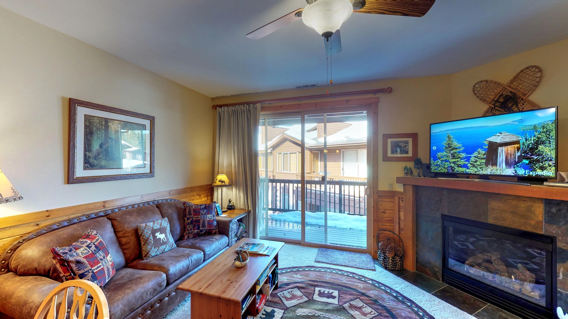 Living room with nearby kitchen and door to deck: Truckee Cinnabar Vacation Retreat
