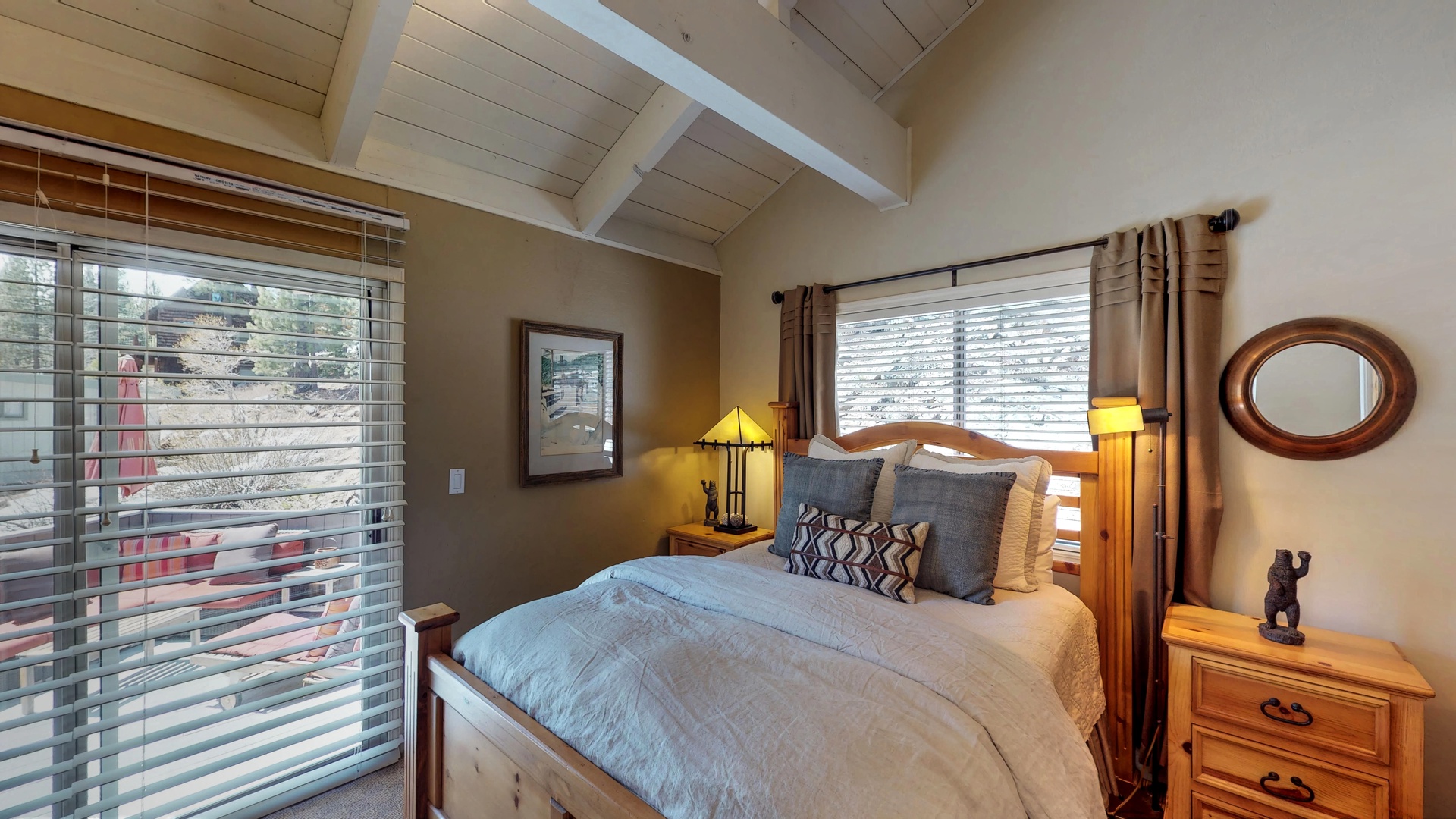 Bedroom with sliding glass door and two nightstands: Eagle's Nest Lodge
