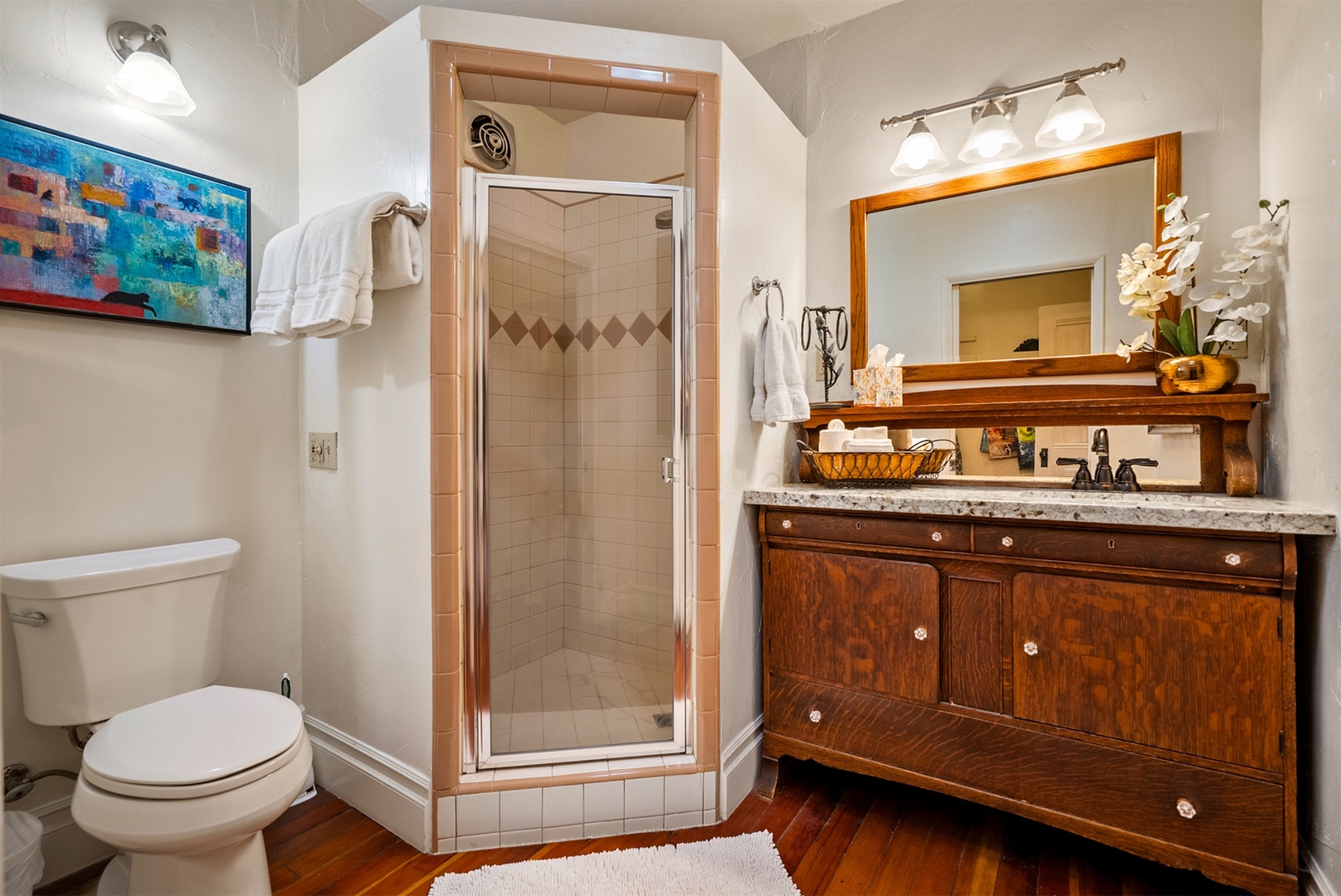 The downstairs bath has a step in shower