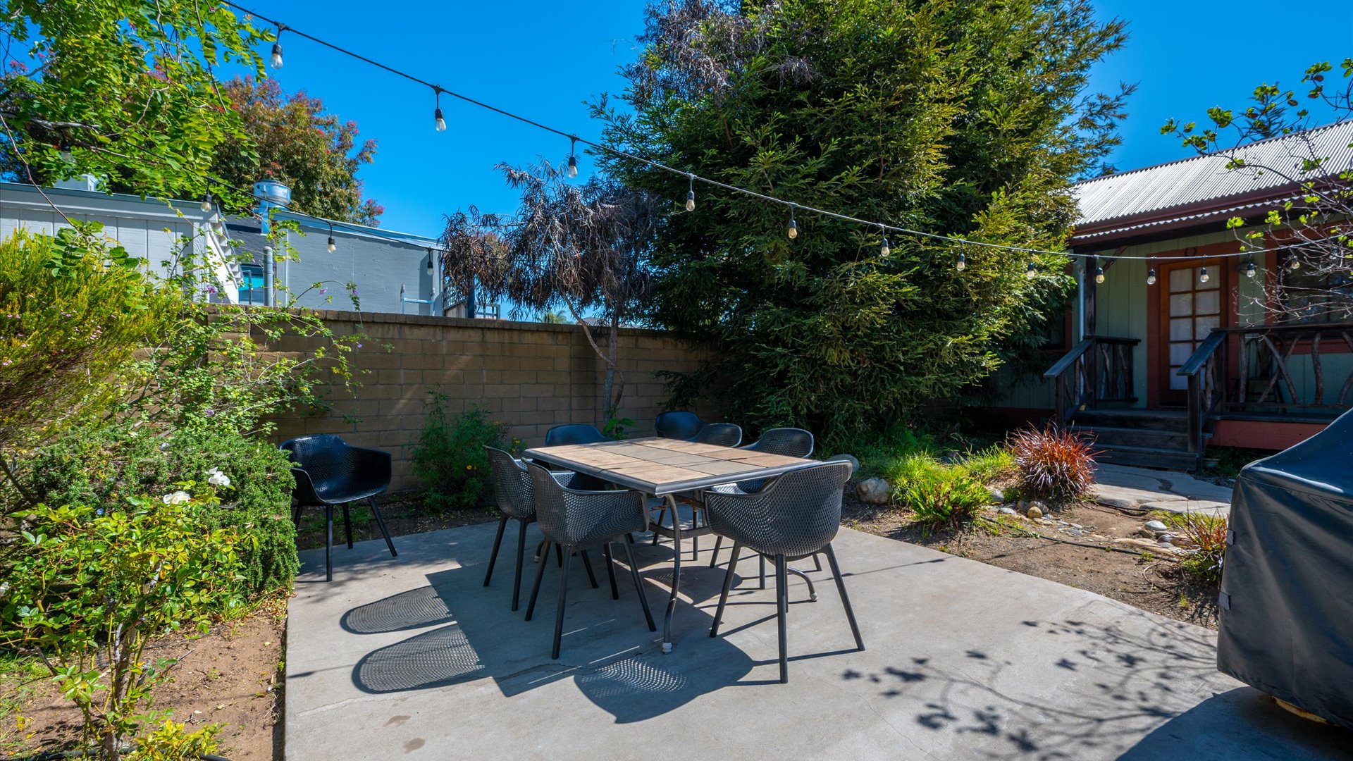 Outdoor dining table located on the back patio, central to the back yard and perfect for spending time with the whole group