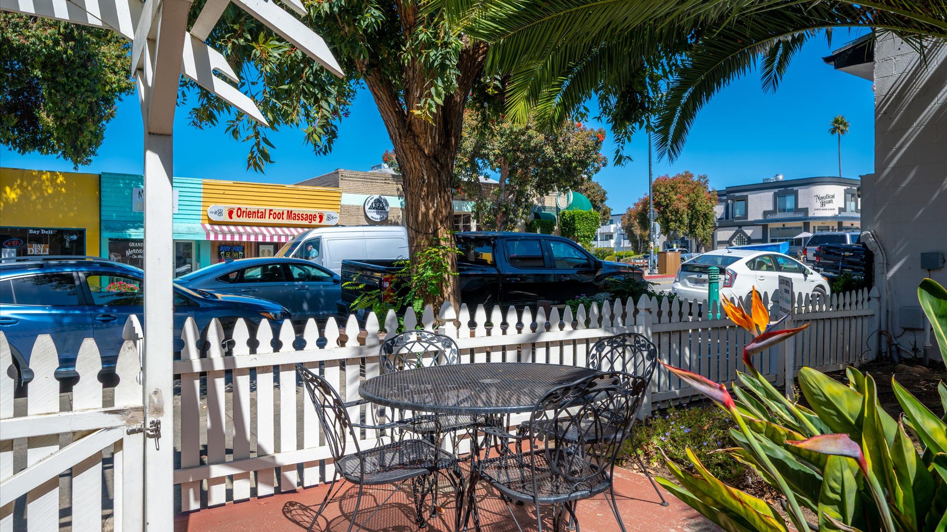 A charming streetside patio offers a peaceful spot to enjoy your morning coffee with downtown just beyond the white picket fence.