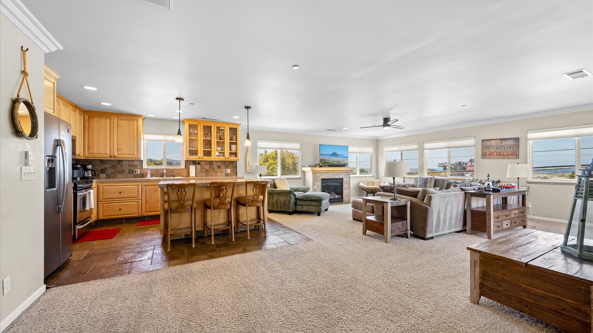 The open-concept living, kitchen, and dining area offer a spacious and cozy space to relax, unwind, and soak in the Morro Bay life