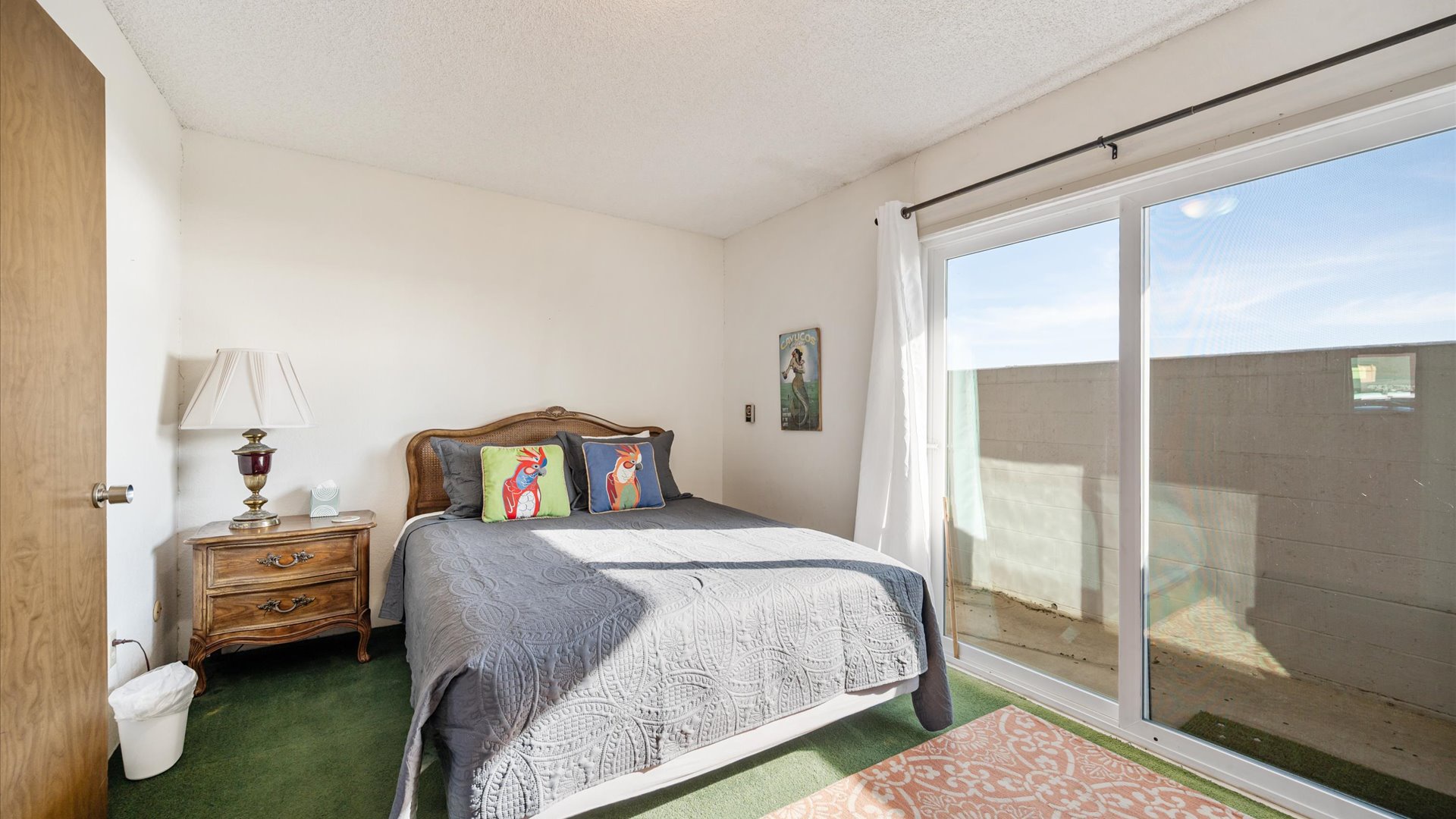 Third bedroom features a king bed and access to the downstairs patio