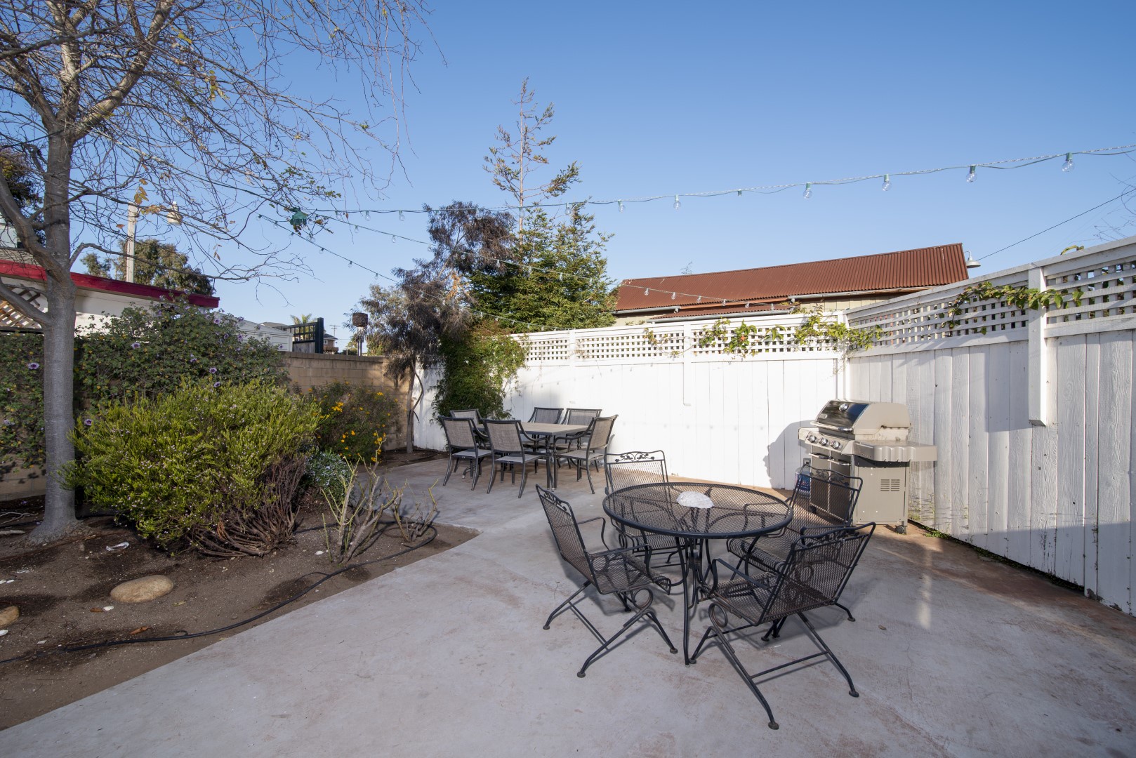 Fenced patio off main home with BBQ grill and patio dining