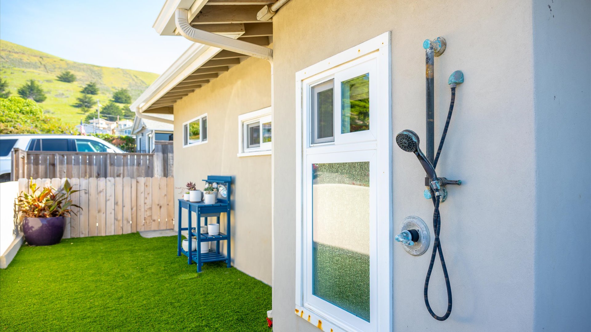 Rinse off after beach days with outdoor shower located in the side yard