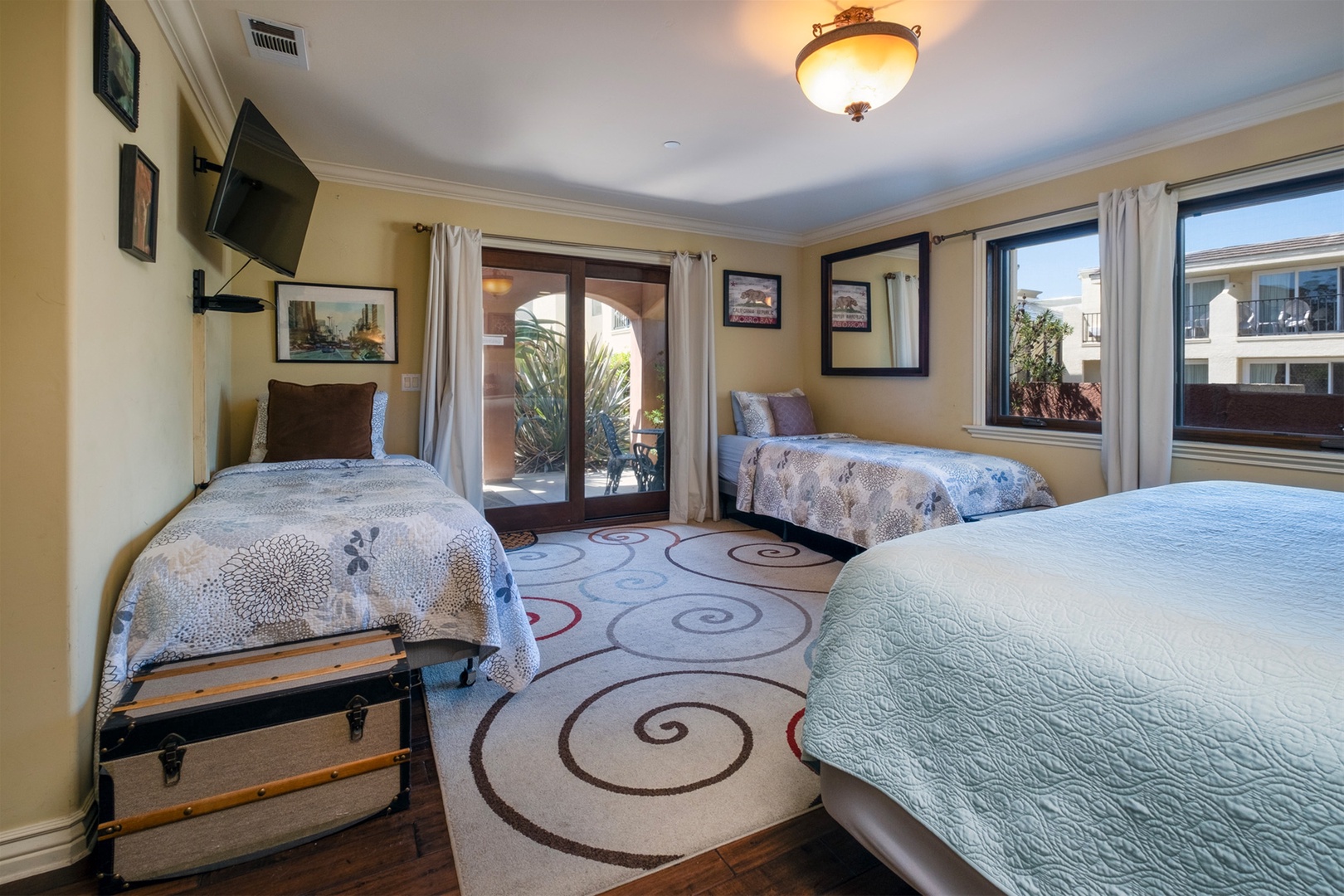 This bedroom also has a TV and access to the back patio