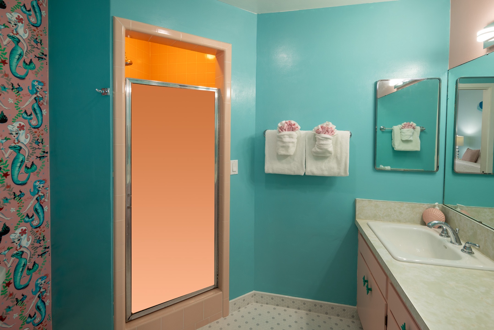 This bathroom is adjoining to the second bedroom and has a step in shower