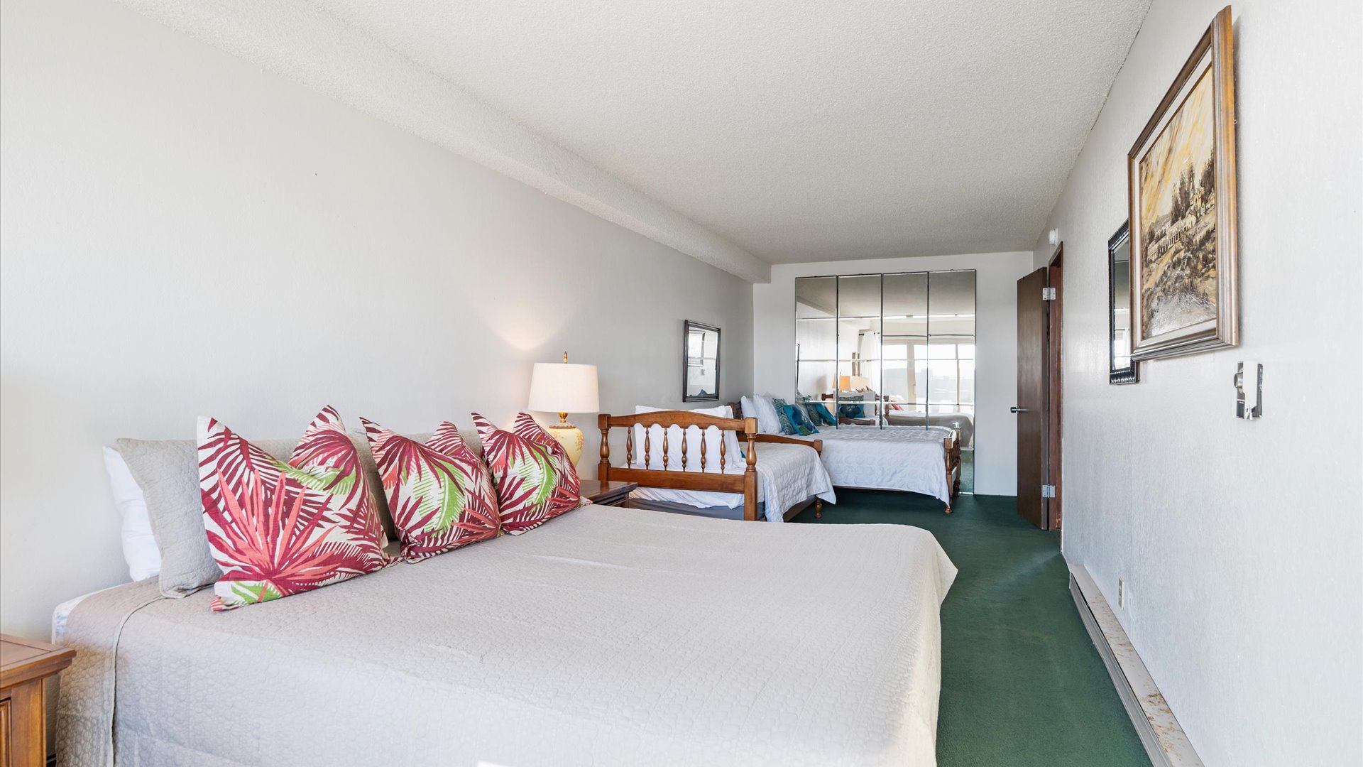 Queen bed, two twins, plus a mirrored wall to help amplify the natural light streaming in