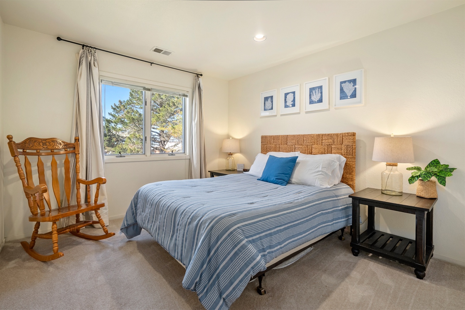 The second bedroom located on the third floor of the home includes a queen bed.