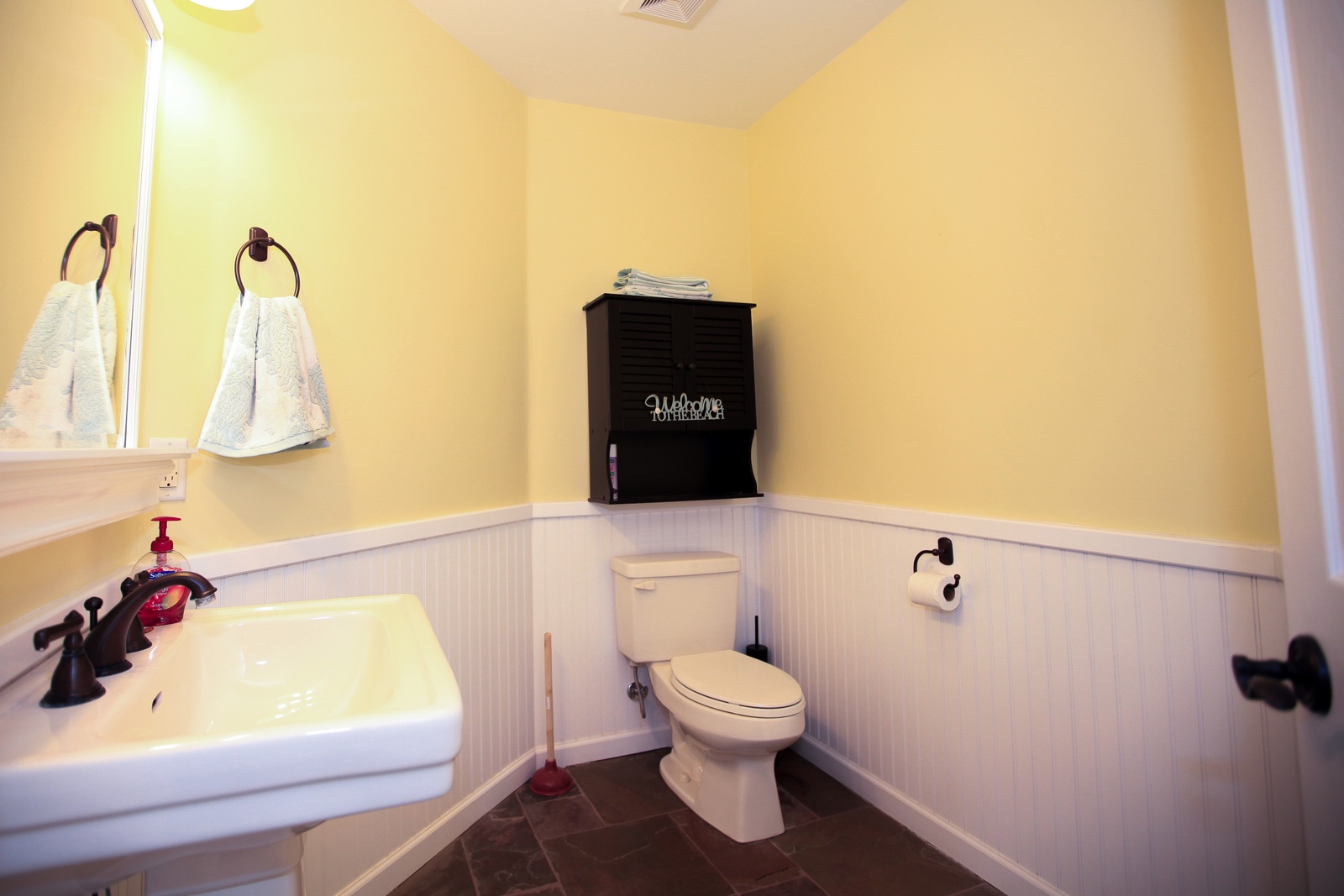 The half bath is upstairs near the living area.
