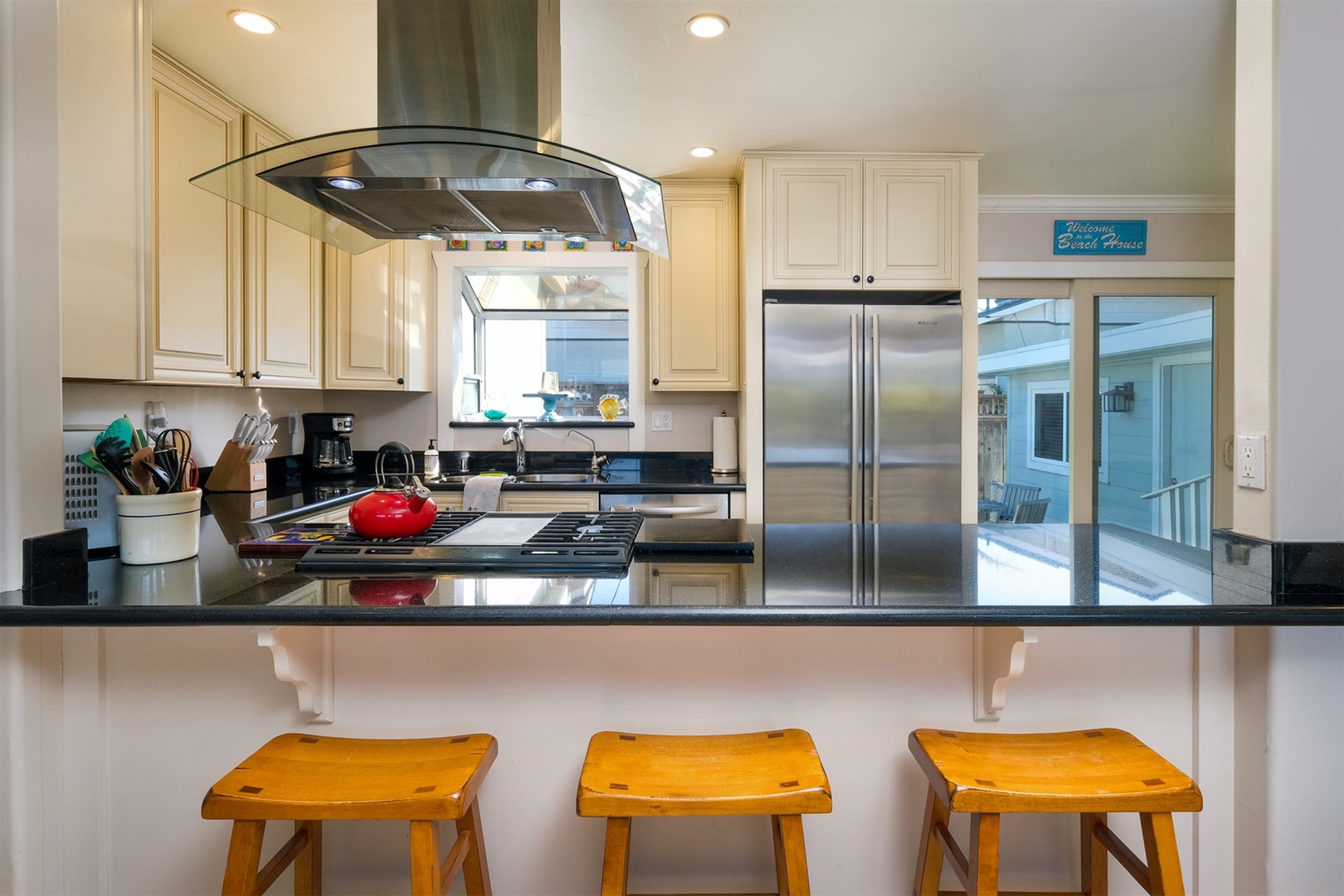 Kitchen includes a gas range, high end appliances and a breakfast bar.