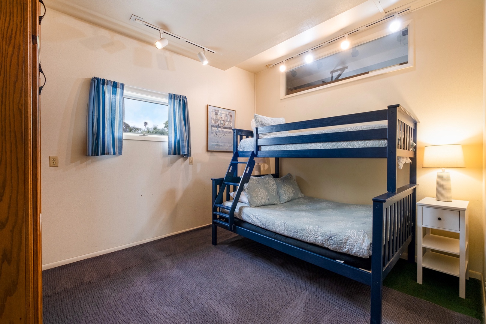 Located tucked off the garage, you`ll find a cozy bedroom with bunk beds. 