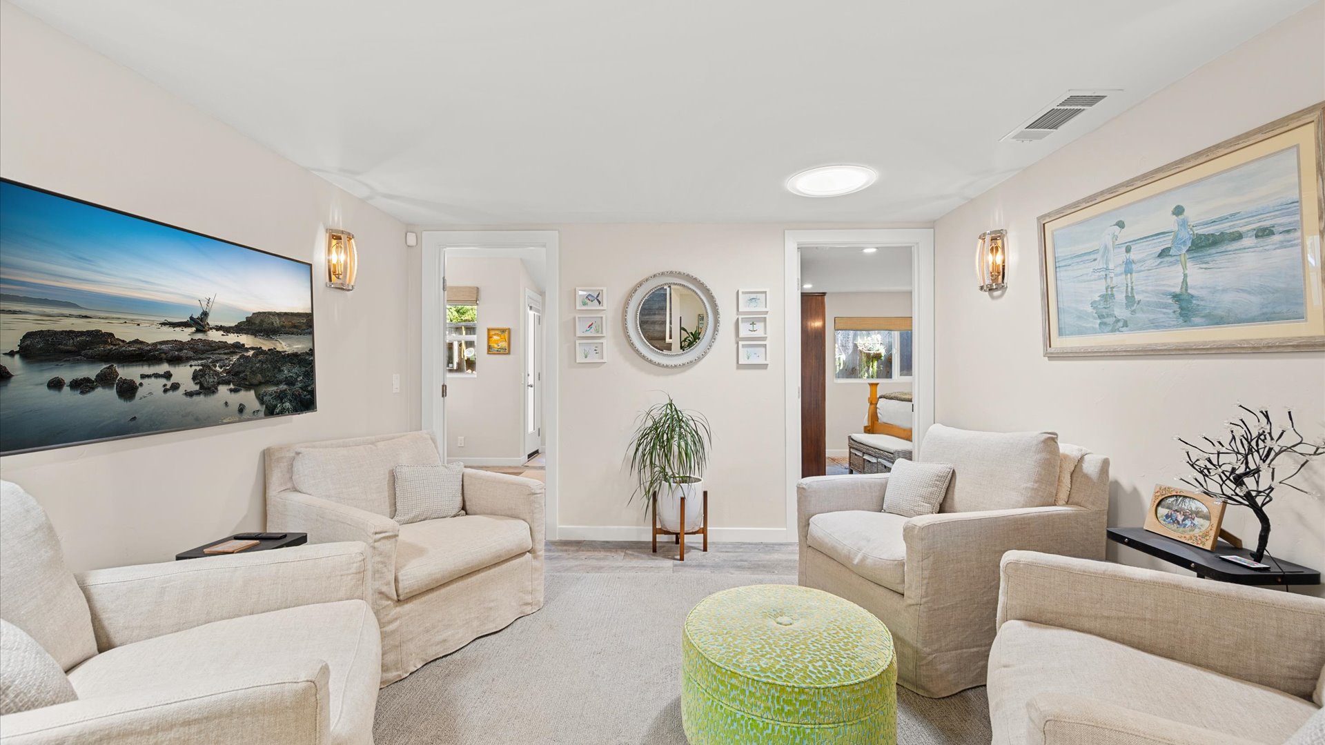 The center family space offers access to the bedrooms and features comfy seating and TV