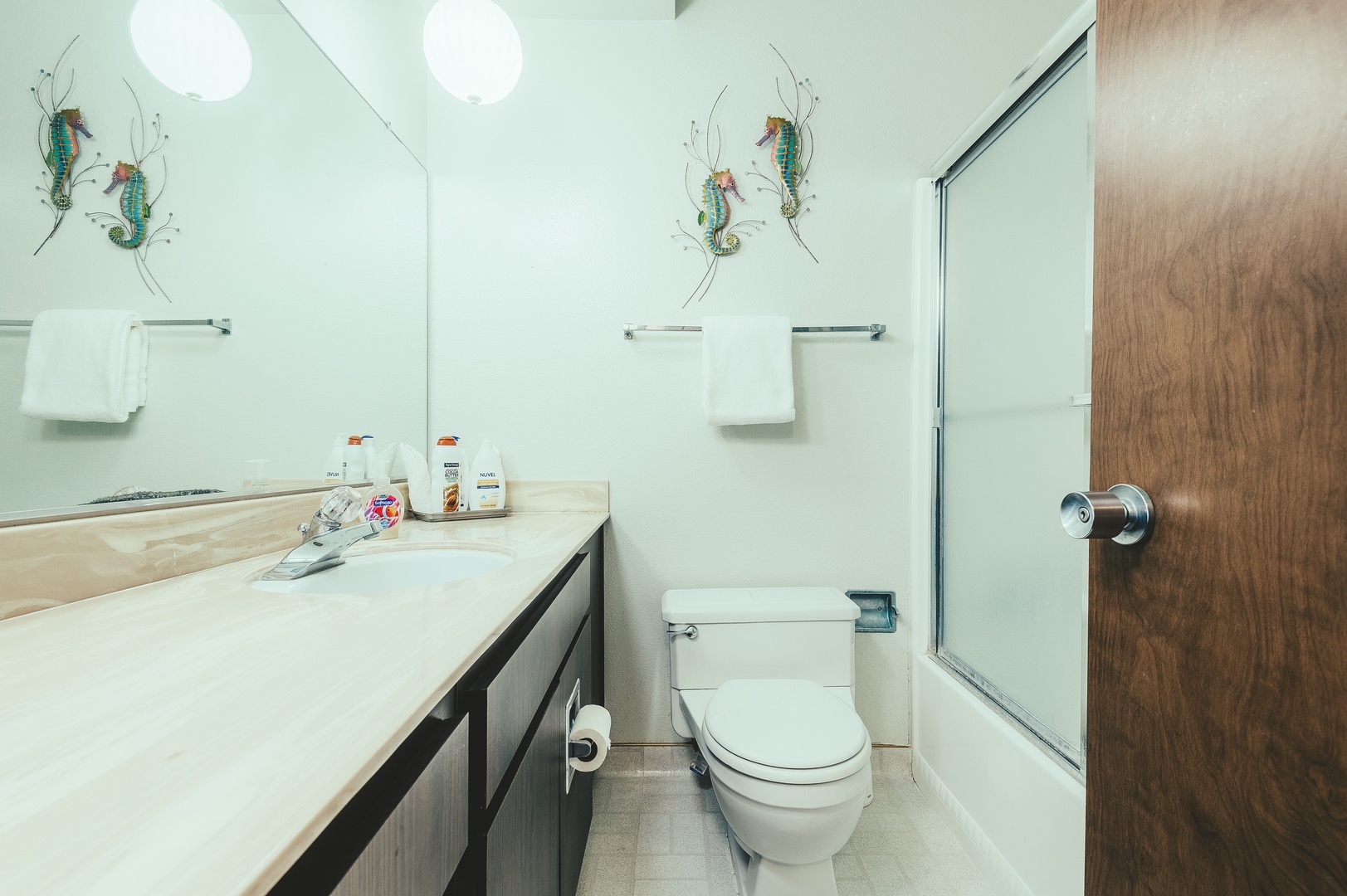 Freshen up in your bright, clean bathroom featuring playful seahorse artwork