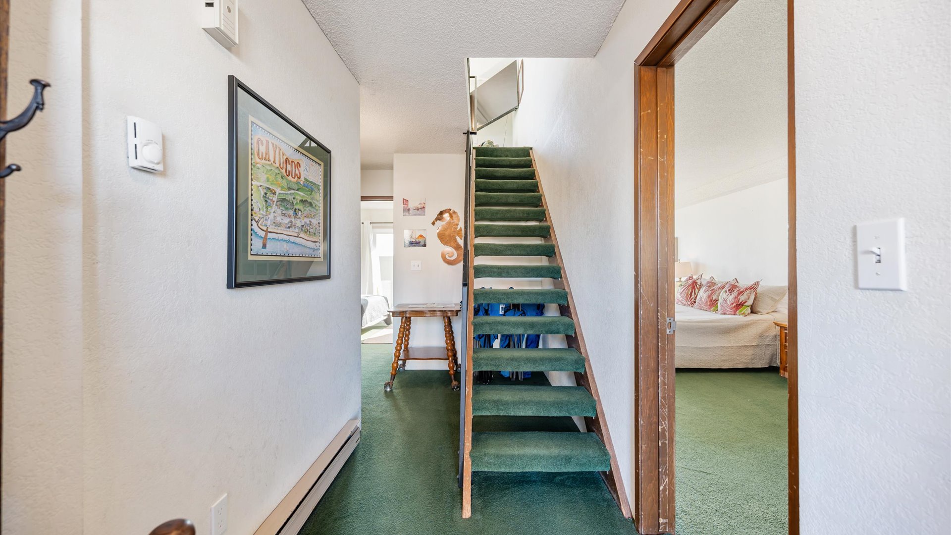 The home features 3 bedrooms downstairs with living area, kitchen, and primary bedroom upstairs