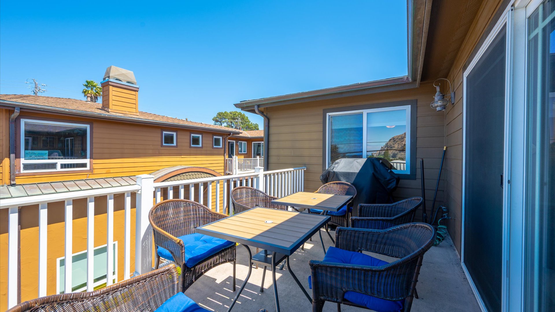 Located off the living room is the deck with outdoor dining and BBQ grill