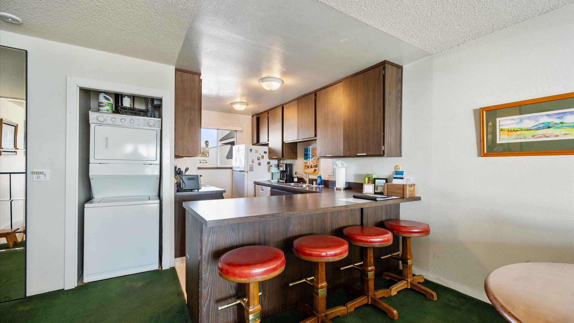 Your fully equipped kitchen features a  bar height counter with stools for casual dining. Washer and dryer also for guest use
