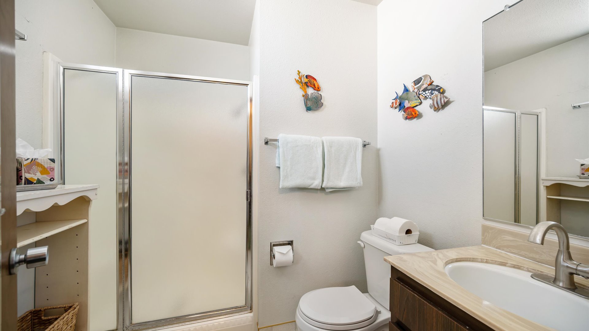 Upstairs bathroom with step in shower and coastal decor