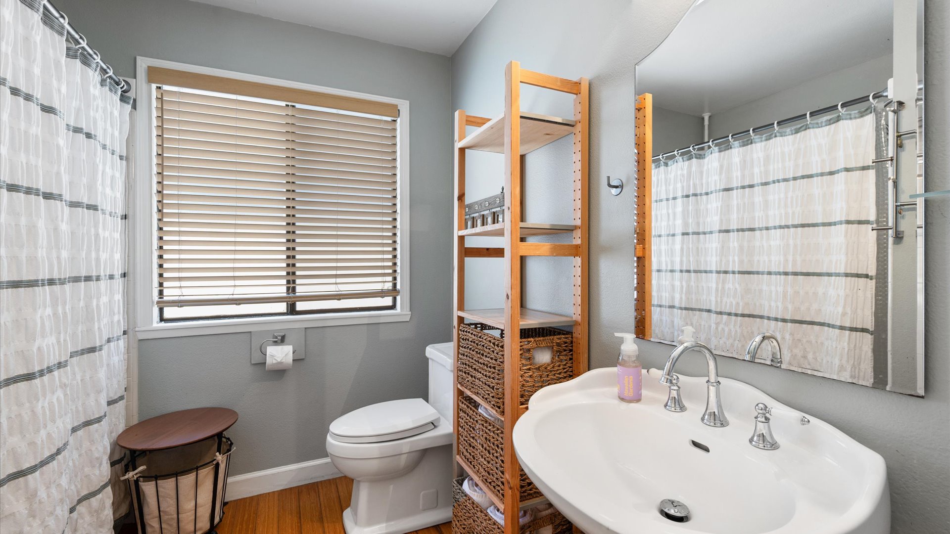 Bathroom is adjacent to the two bedrooms and features a shower/tub combo.