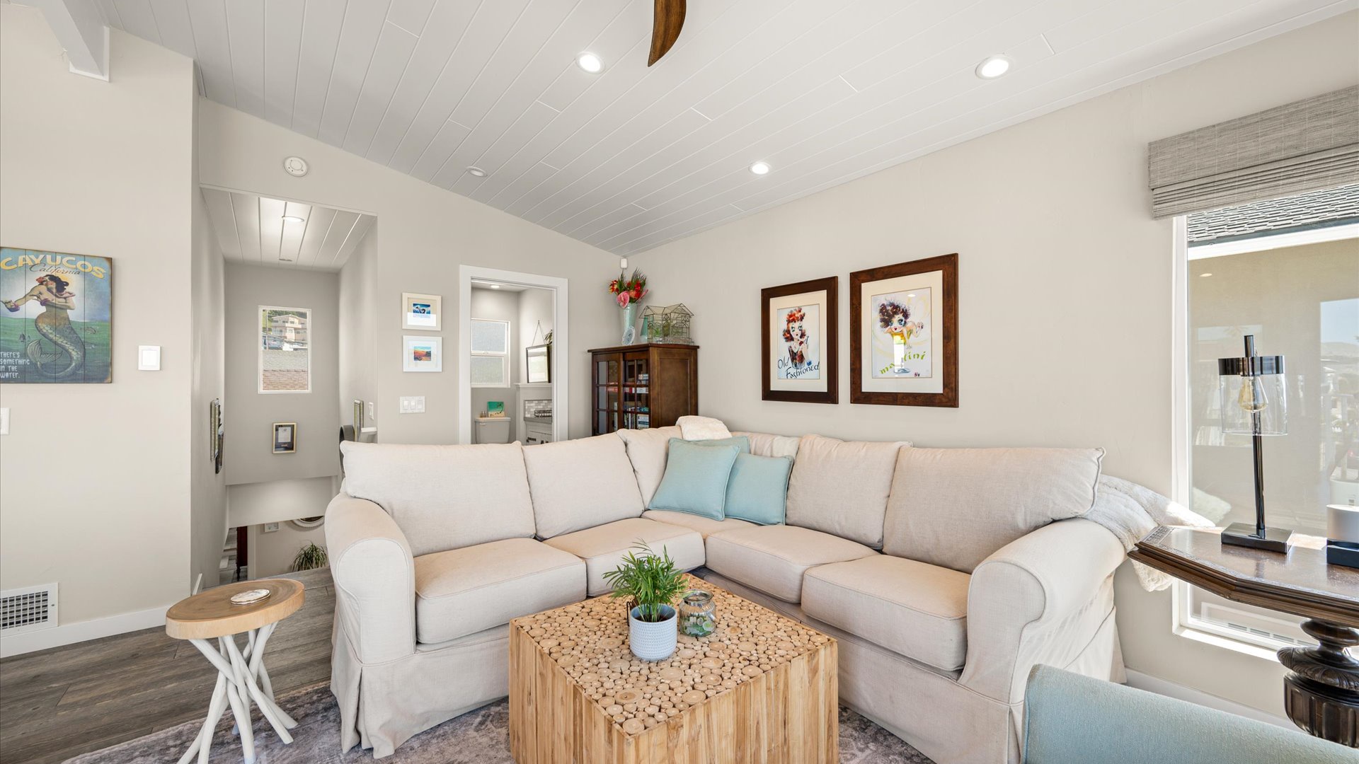 Unwind in the open living space with plush sectional seating and coastal charm