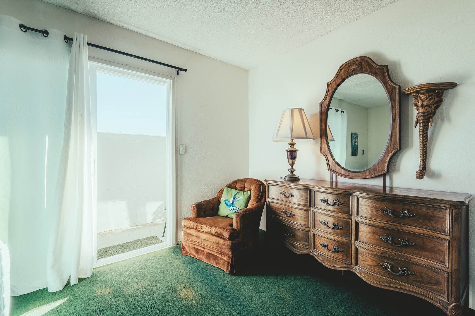 Relax in your private sitting area with vintage charm and natural light streaming through the window.