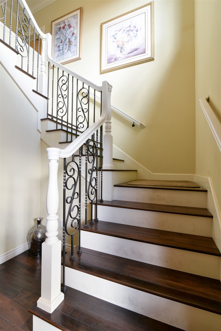 Stairs take you between the downstairs bedrooms and upper floor