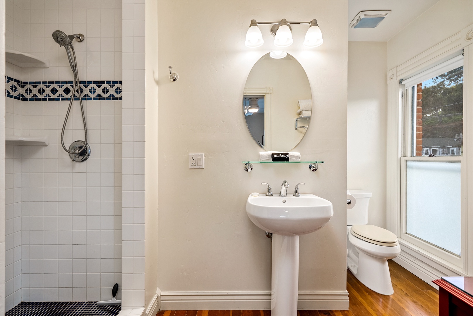 Adjoining bath to second bedroom with step in shower